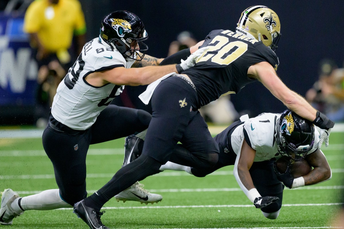 Jacksonville Jaguars running back Travis Etienne Jr. (1) runs against New Orleans Saints linebacker Pete Werner (20). Mandatory Credit: Matthew Hinton-USA TODAY