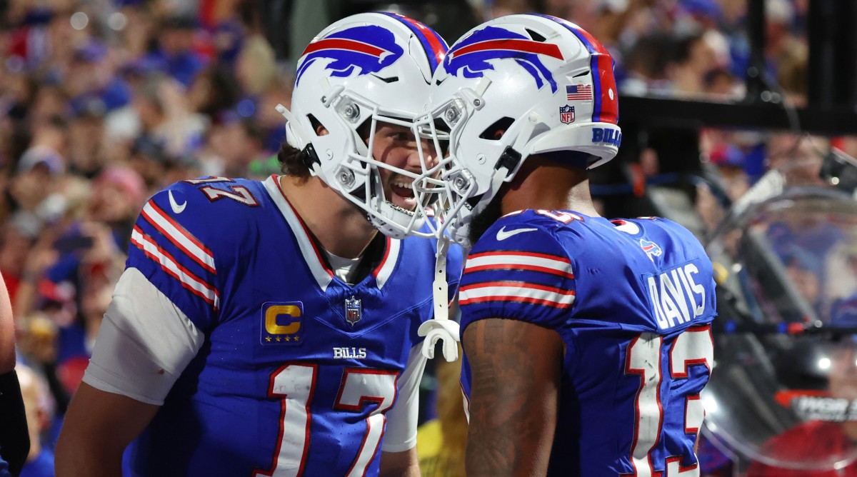 Bills quarterback Josh Allen (17) celebrates his touchdown pass to wide receiver Gabe Davis (13) in the second half of a game against the Buccaneers.