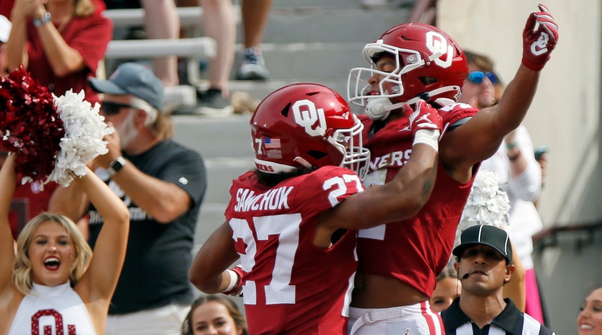 Oklahoma running back Gavin Sawchuk (27) and wide receiver Nic Anderson, right, celebrate after a touchdown.