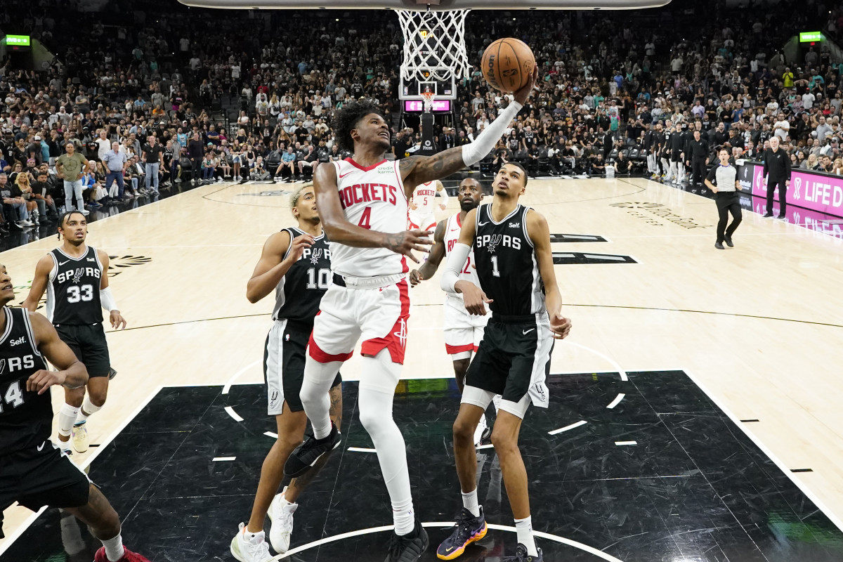 Rockets guard Jalen Green drives to the basket past San Antonio Spurs forwards Victor Wembanyama (1) and Jeremy Sochan during the second half at Frost Bank Center.