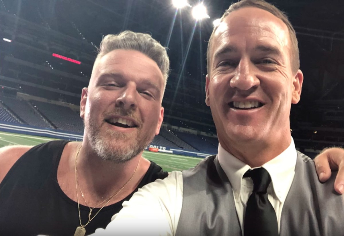 Former Indianapolis Colts Peyton Manning and Pat McAfee take a selfie on the field at Lucas Oil Stadium after an episode of Peyton's Places.