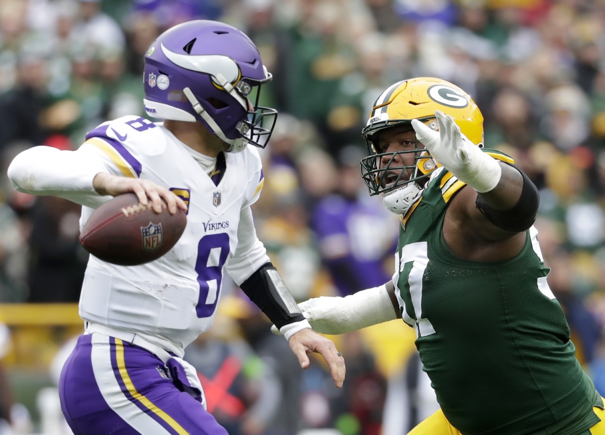 Oct 29, 2023; Green Bay, Wisconsin, USA; Green Bay Packers defensive tackle Kenny Clark (97) pressures Minnesota Vikings quarterback Kirk Cousins (8) during their football game at Lambeau Field.