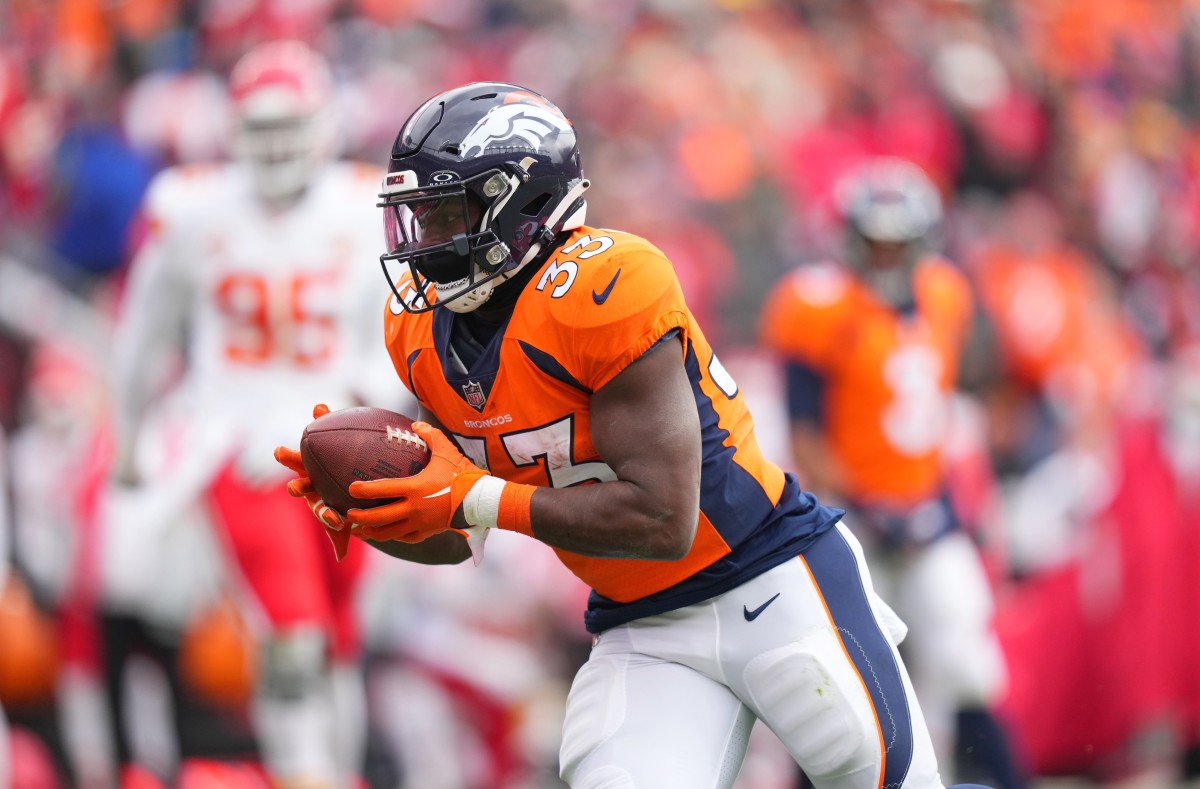 Denver Broncos running back Javonte Williams (33) carries the ball for a touchdown against the Kansas City Chiefs in the first quarter at Empower Field at Mile High.