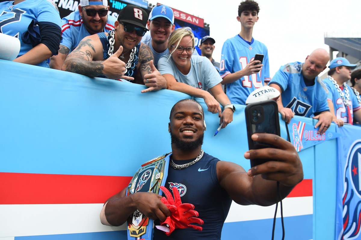 Tennessee Titans linebacker Azeez Al-Shaair (2) takes a selfie with fans before the game against the Atlanta Falcons at Nissan Stadium.