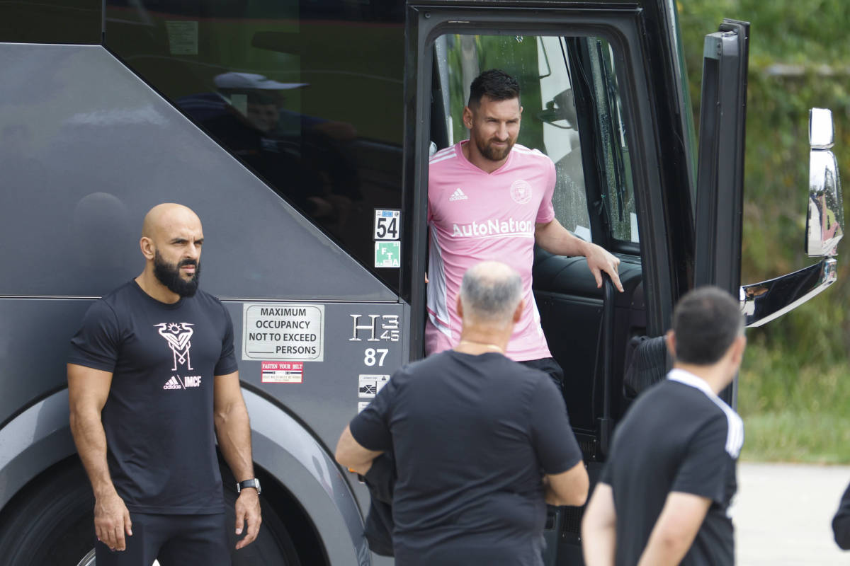 Bodyguard Yassine Chueko pictured (left) watching on as Lionel Messi gets off Inter Miami's team bus in September 2023