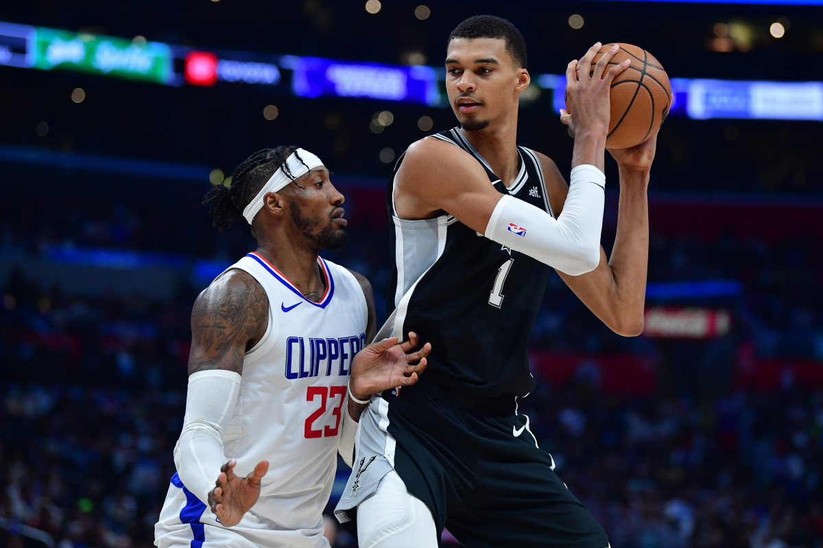 San Antonio Spurs center Victor Wembanyama (1) controls the ball against Los Angeles Clippers forward Robert Covington (23) during the second half at Crypto.com Arena.