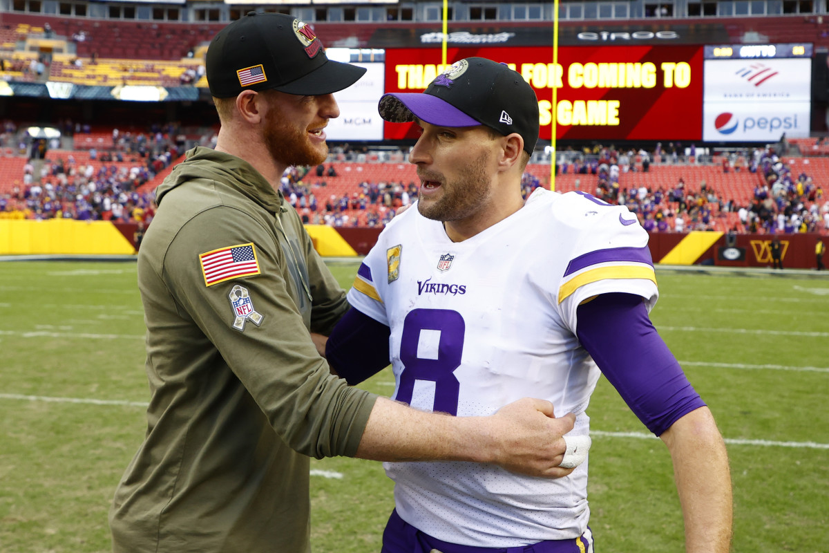 Nov 6, 2022; Landover, Maryland, USA; Injured Washington Commanders quarterback Carson Wentz (L) hugs Minnesota Vikings quarterback Kirk Cousins (8) after their game at FedExField. 