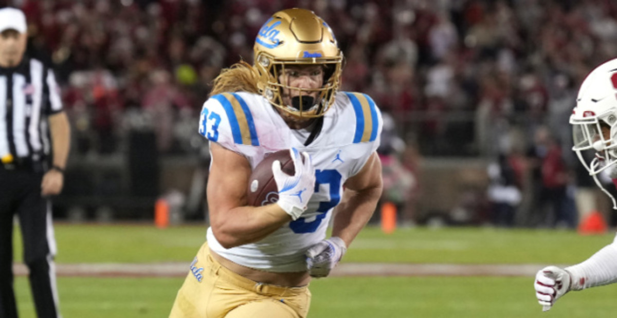 UCLA Bruins tailback Carson Steele on a rushing attempt during a college football game.