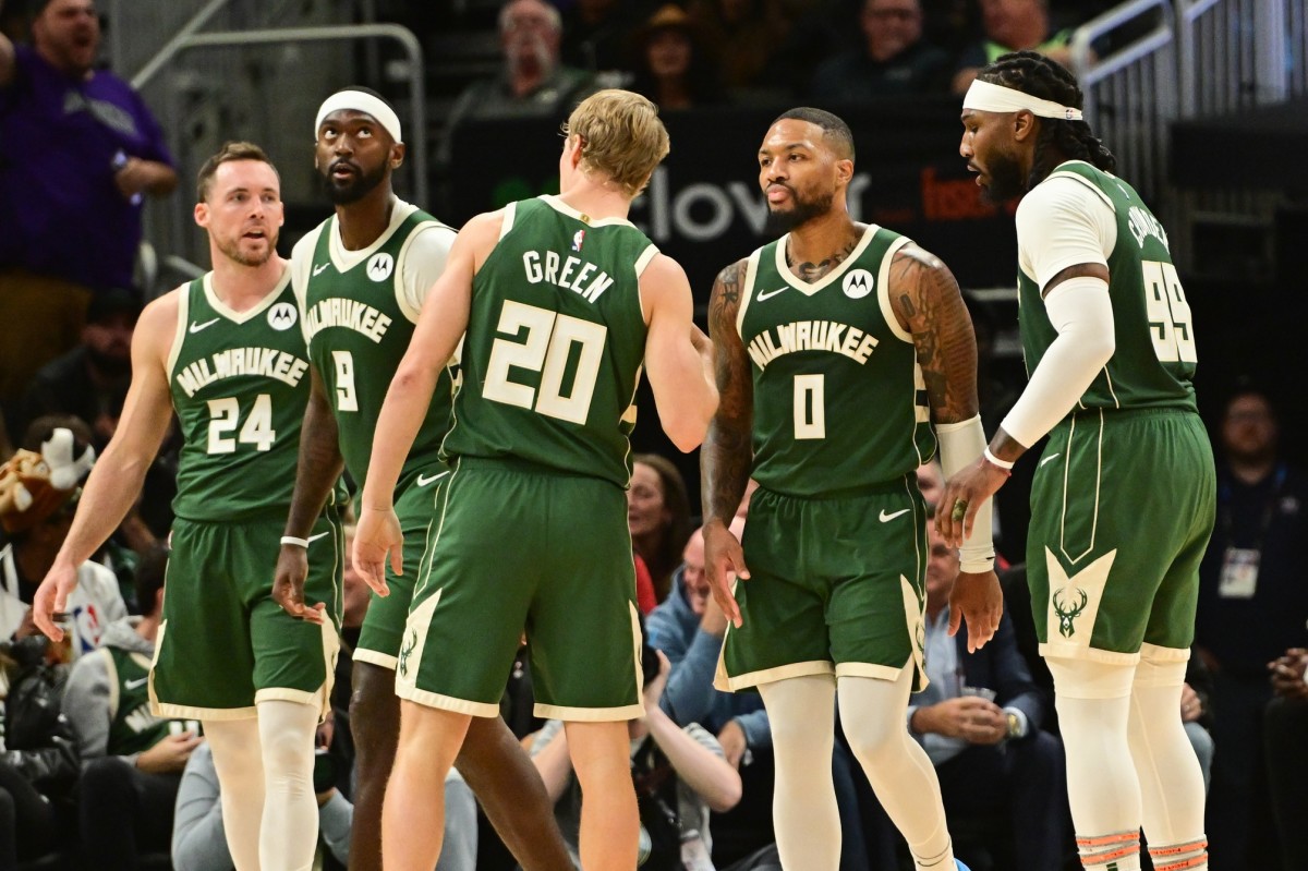 Milwaukee Bucks guard Damian Lillard (0) stands with teammates 