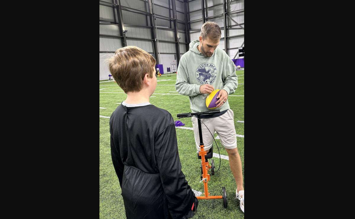 Kirk Cousins signs an autograph at the Kids Club trick-or-treat event on Monday, Oct. 30. 