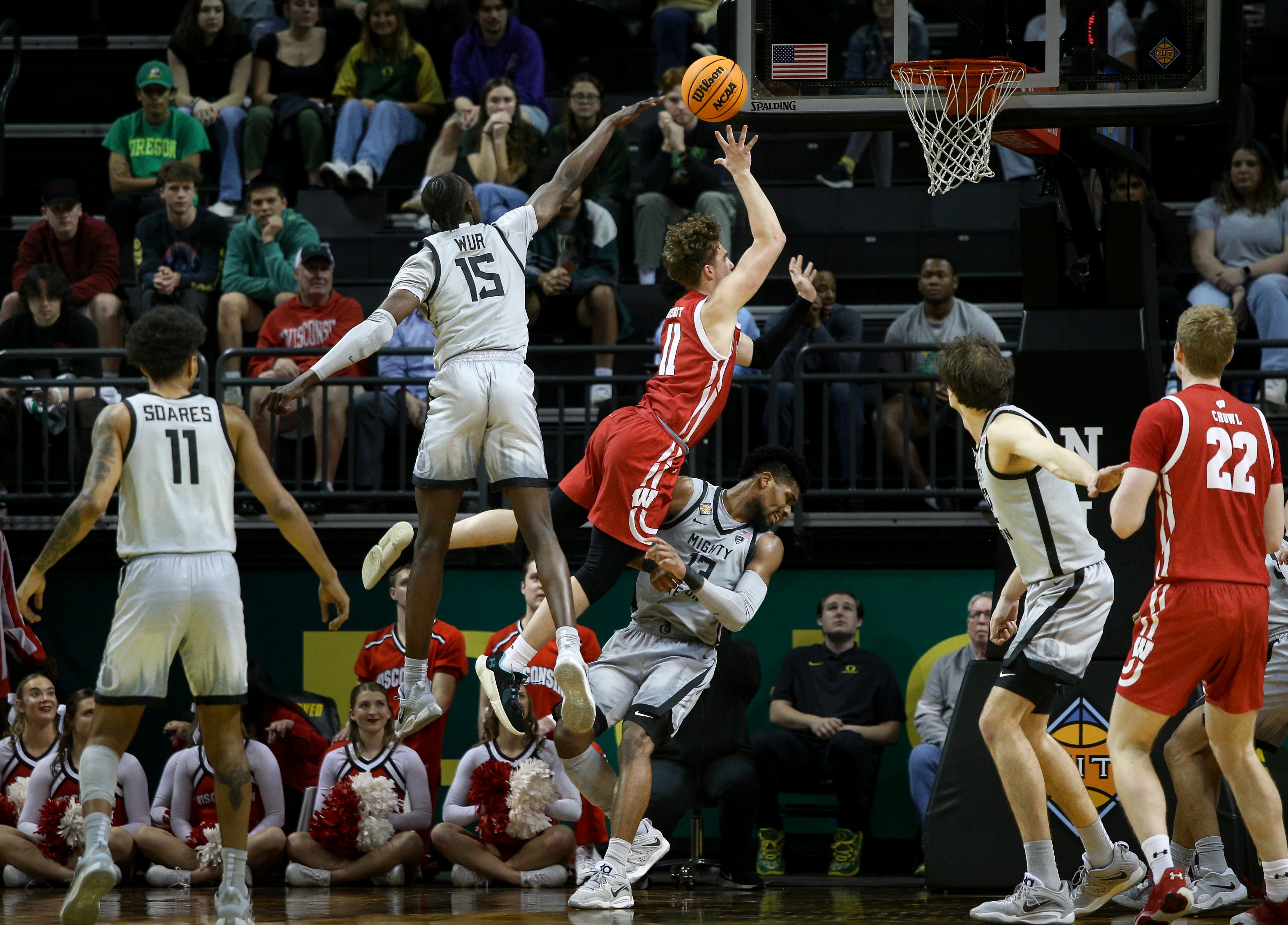 Wisconsin guard Max Klesmit fouls Oregon forward Quincy Guerrier as the Oregon Ducks host Wisconsin in the quarterfinal round of the NIT Tuesday, March 21, 2023 at Matthew Knight Arena in Eugene, Ore. Ncaa Basketball Wisconsin At Oregon Mbb Nit Wisconsin At Oregon