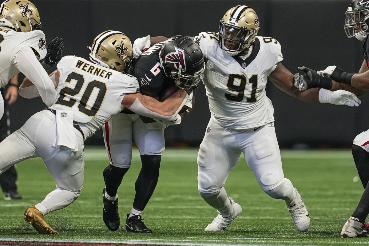 Sep 11, 2022; Atlanta, Georgia, USA; Atlanta Falcons running back Damien Williams (6) is tackled by New Orleans Saints linebacker Pete Werner (20) and defensive tackle Kentavius Street (91) during the first quarter at Mercedes-Benz Stadium. 