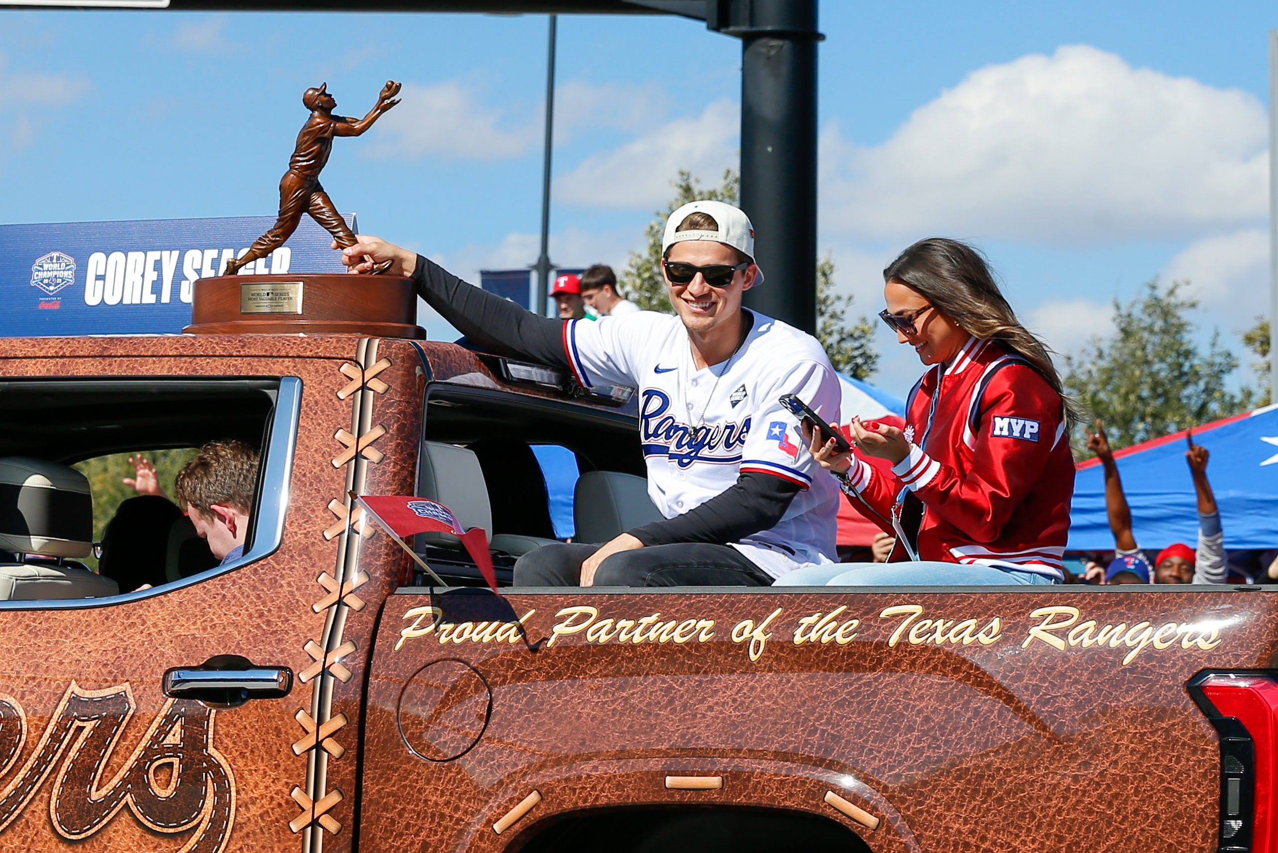 Texas Rangers shortstop Corey Seager holds onto the World Series MVP trophy during the World Series championship parade Friday afternoon at Globe Life Field.