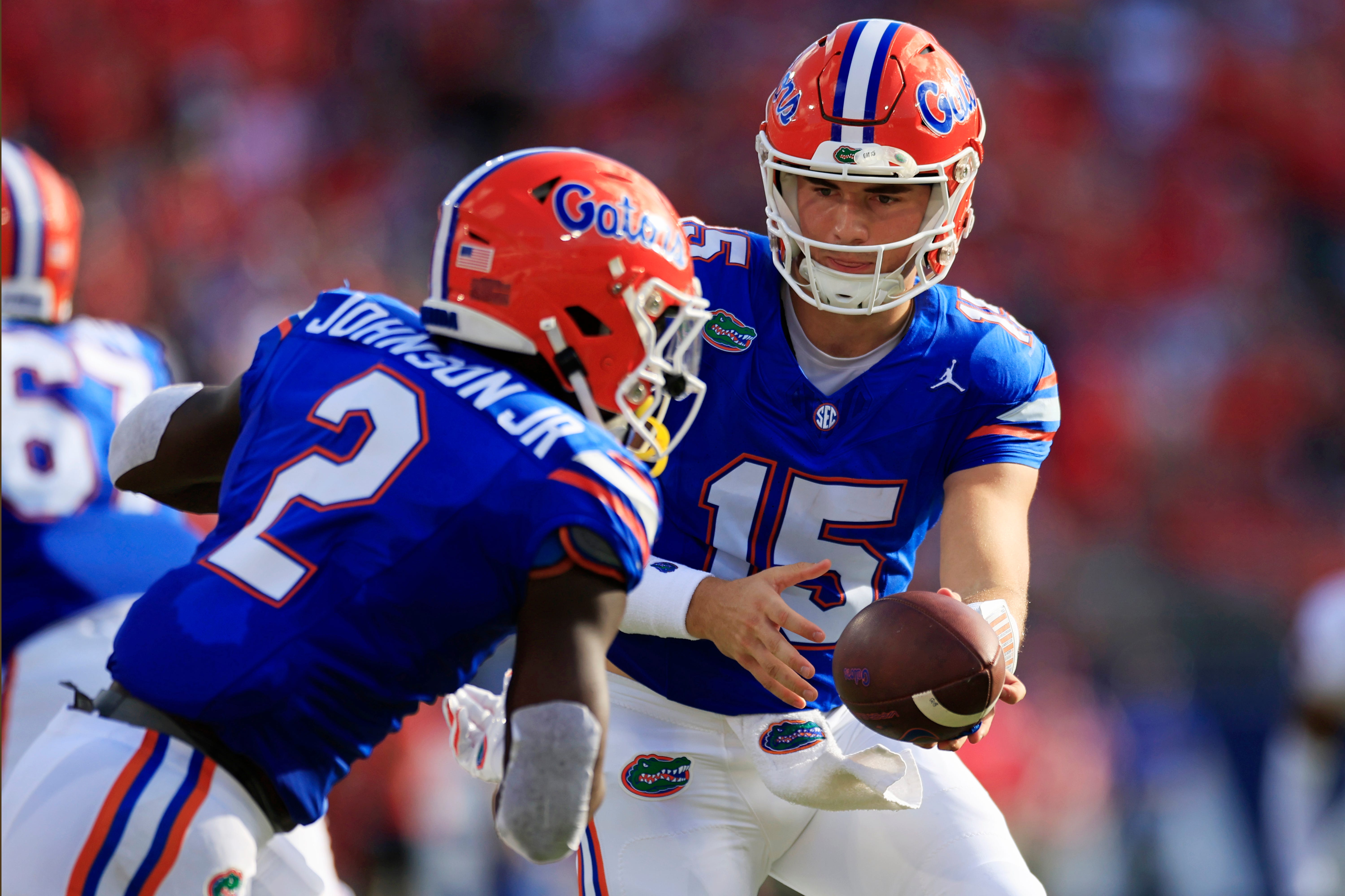 Florida Gators quarterback Graham Mertz (15) hands off to running back Montrell Johnson Jr. (2) during the first quarter of an NCAA football game Saturday, Oct. 28, 2023 at EverBank Stadium in Jacksonville, Fla. Georgia defeated Florida 43-20. [Corey Perrine/Florida Times-Union]