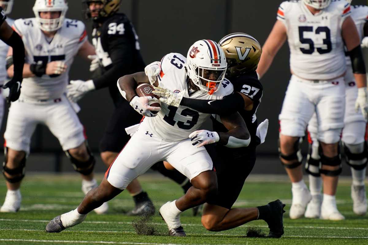 Auburn tight end Rivaldo Fairweather (13) is brought down by Vanderbilt safety John Howse IV (27) during the first quarter at FirstBank Stadium in Nashville, Tenn., Saturday, Nov. 4, 2023. 