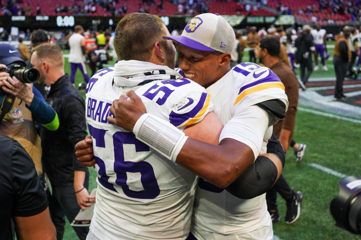 Minnesota Vikings center Garrett Bradbury and quarterback Joshua Dobbs hug after their victory over the Atlanta Falcons at Mercedes-Benz Stadium.