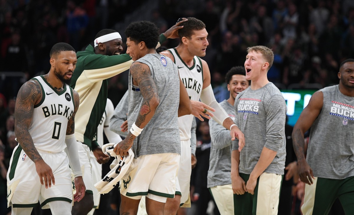 Milwaukee Bucks forward Bobby Portis (9) celebrates a three-point shot by Milwaukee Bucks center Brook Lopez (11) 