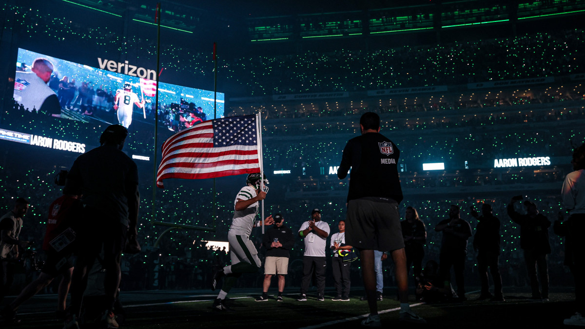 New York Jets quarterback Aaron Rodgers runs on to the field at MetLife Stadium before their Week 1 game against the Buffalo Bills.