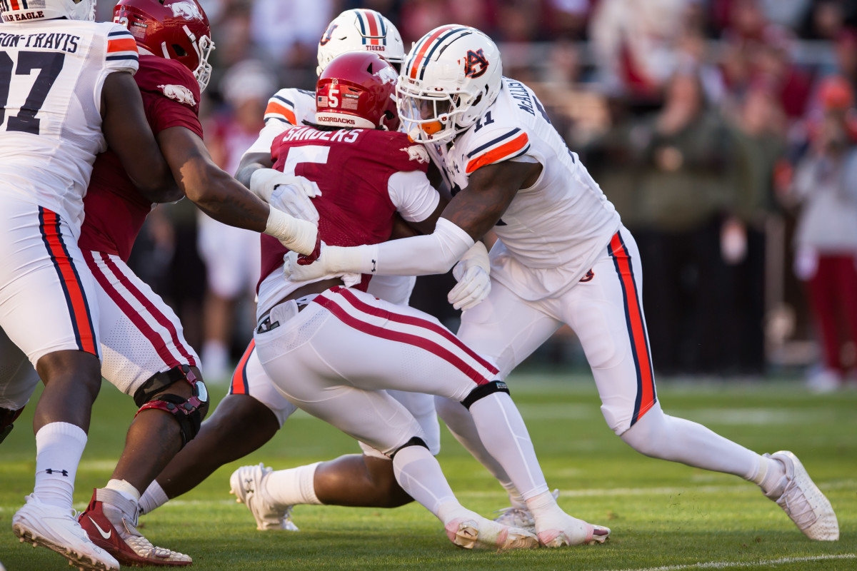 Nov 11, 2023; Fayetteville, Arkansas, USA; Auburn Tigers linebacker Elijah McAllister (11) tackles Arkansas Razorbacks running back Raheim Sanders (5) during the second quarter at Donald W. Reynolds Razorback Stadium. Mandatory Credit: Brett Rojo-USA TODAY Sports  