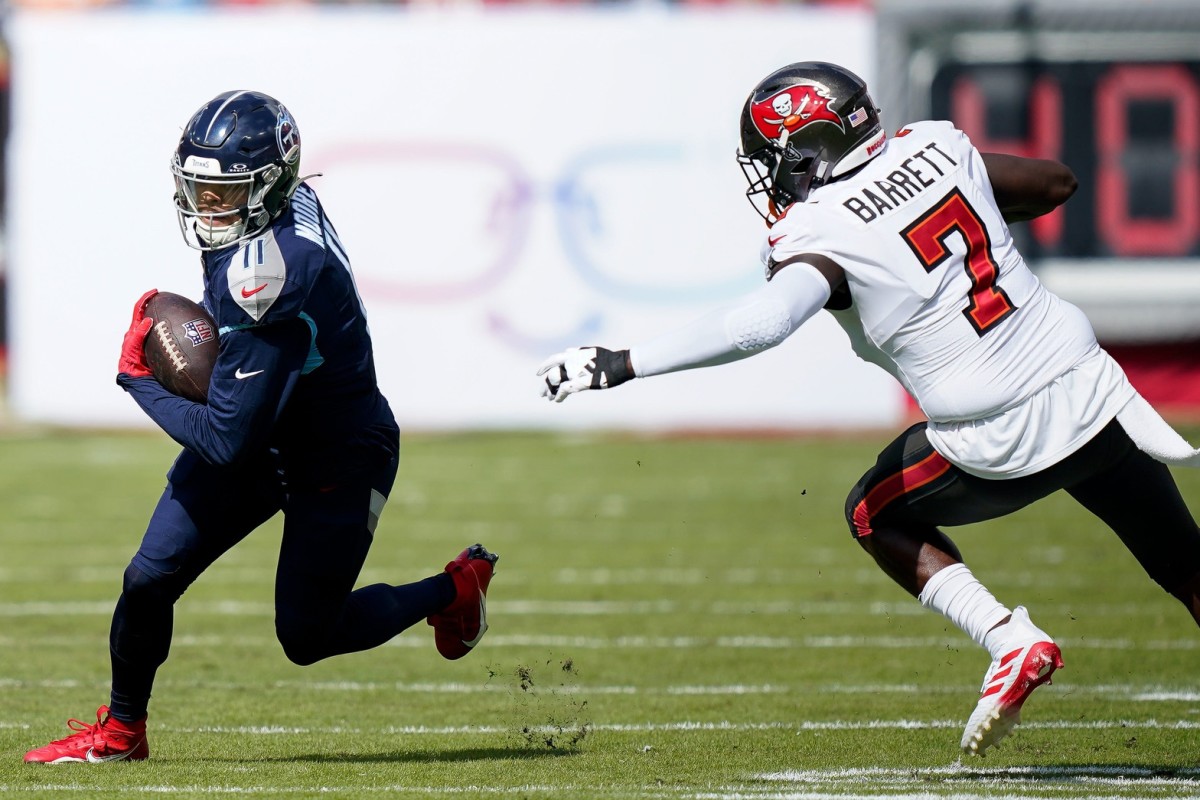 Tennessee Titans wide receiver Chris Moore (11) runs the ball past Tampa Bay Buccaneers linebacker Shaquil Barrett (7) during the first quarter at Raymond James Stadium.