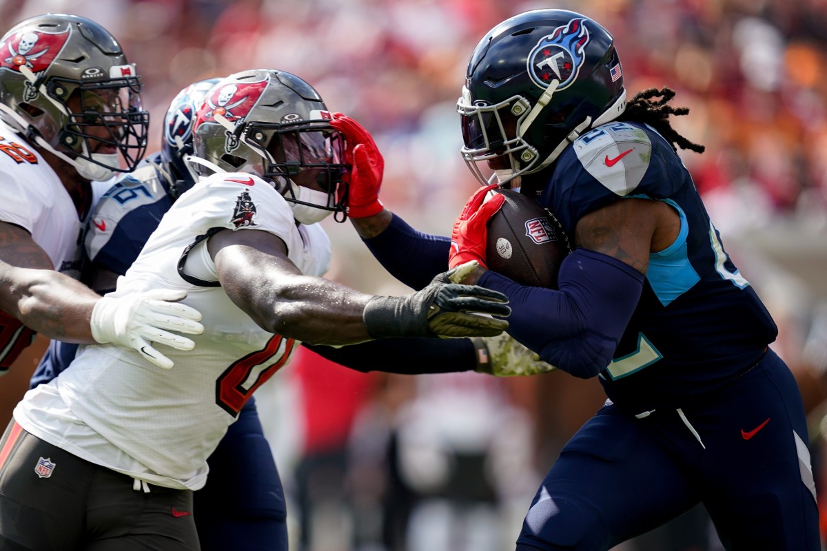 Tennessee Titans running back Derrick Henry (22) runs the ball towards Tampa Bay Buccaneers linebacker Yaya Diaby (0) during the first quarter at Raymond James Stadium.