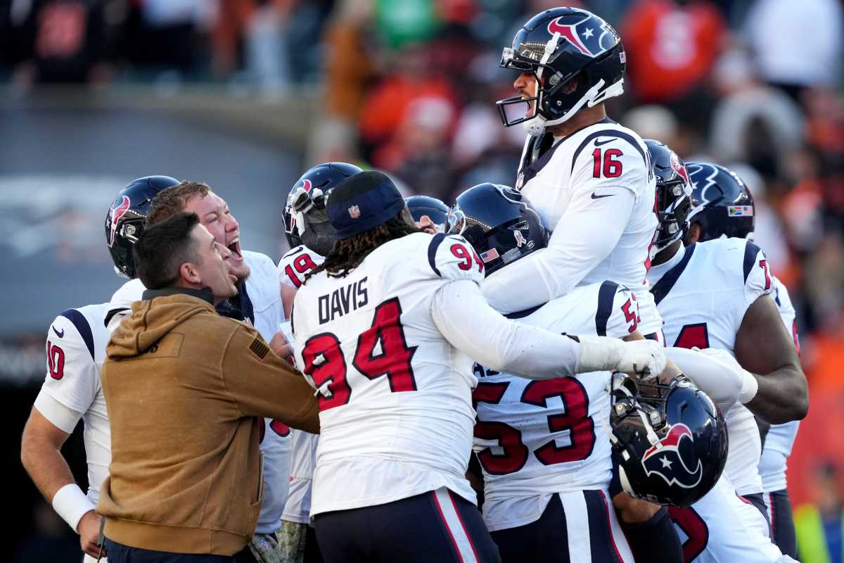 Matt Amendola is lifted up in the air by a group of his teammates after kicking the game-winning field goal