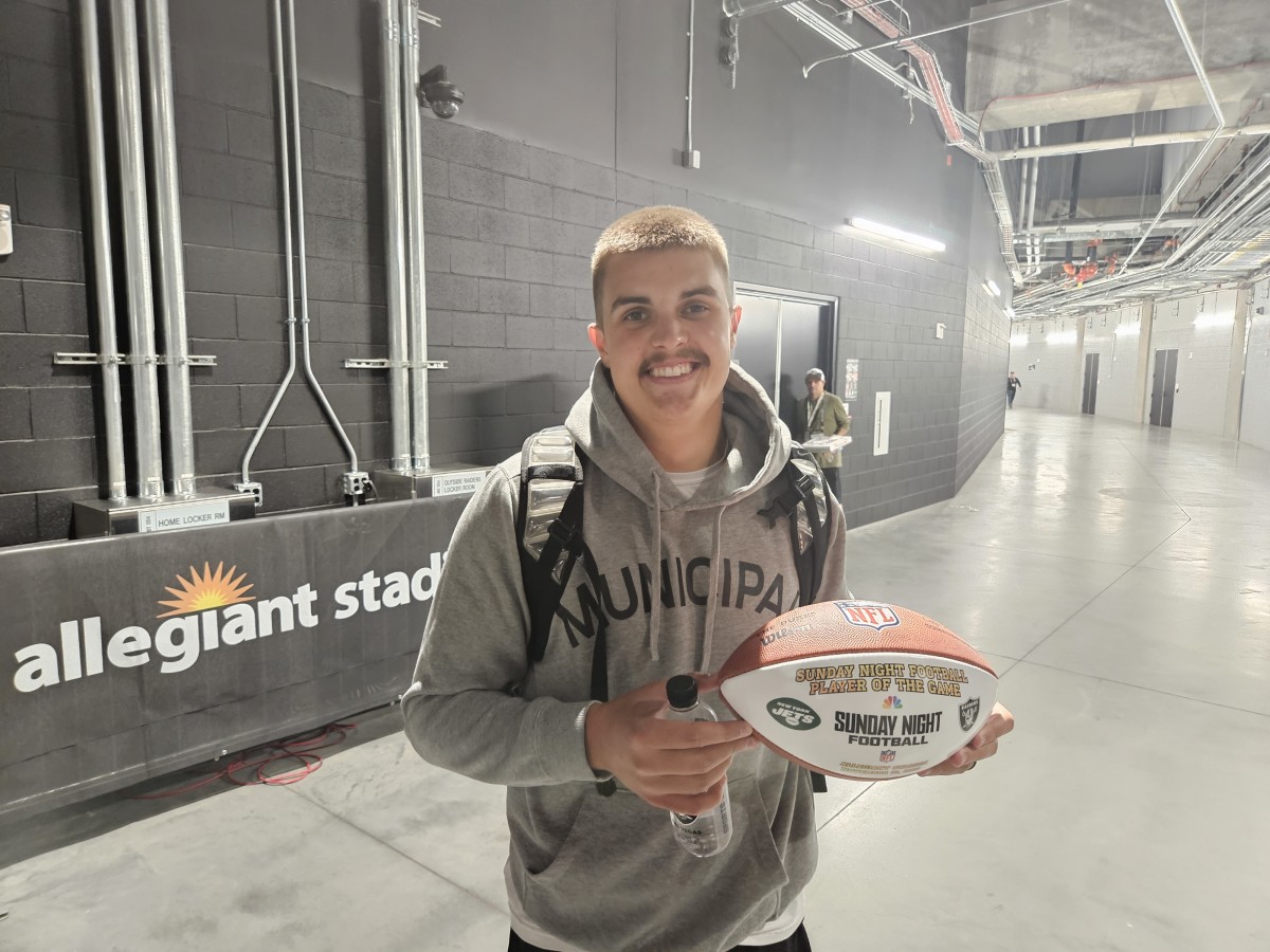 Las Vegas Raiders rookie quarterback Aidan O'Connell holding his game ball from a win over the New York Jets.