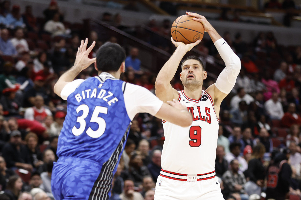 Chicago Bulls center Nikola Vucevic (9) shoots against Orlando Magic center Goga Bitadze (35) during the first half at United Center.