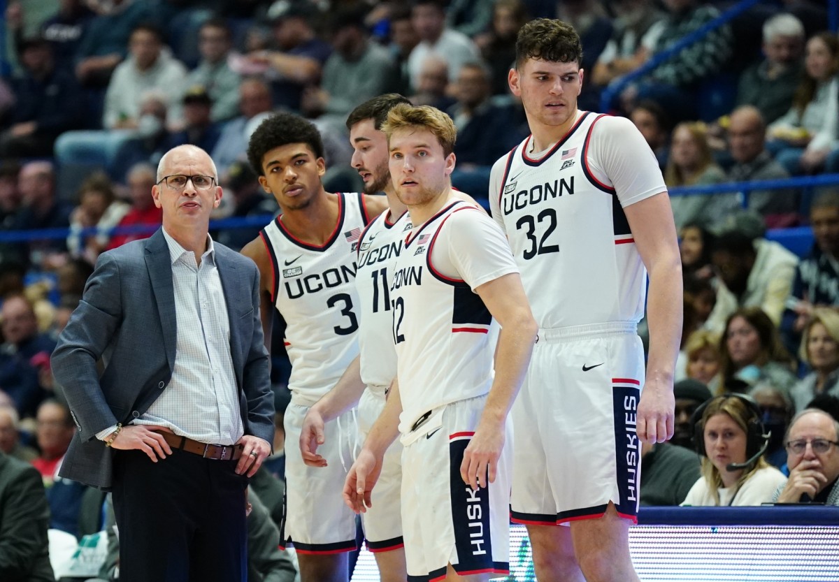 UConn Huskies head coach Dan Hurley talks with forward Jaylin Stewart (3), forward Alex Karaban (11), center Donovan Clingan (32) and guard Cam Spencer (12) from the sideline as they take on the Stonehill Skyhawks at XL Center.