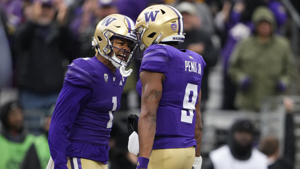 Washington's Rome Odunze and Michael Penix Jr. celebrate after a touchdown