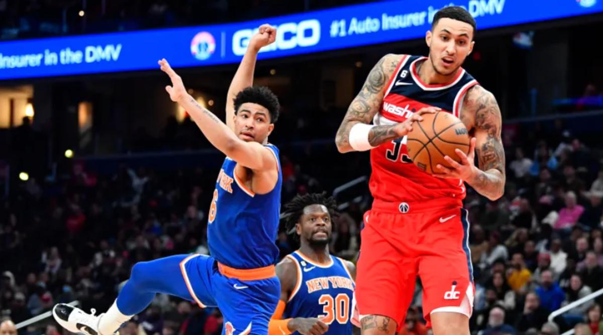 Kyle Kuzma fights for a rebound against Quentin Grimes and Julius Randle (30) last season