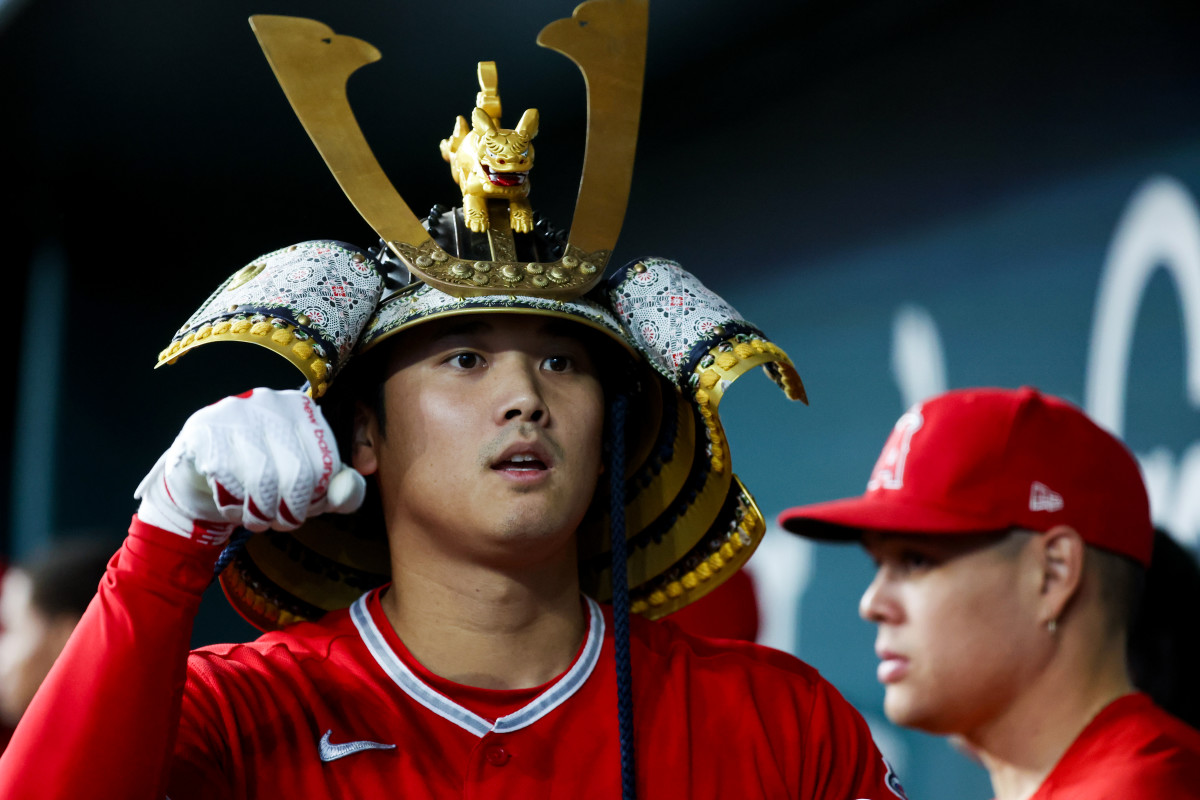 Aug 16, 2023; Arlington, Texas, USA; Los Angeles Angels designated hitter Shohei Ohtani (17) celebrates with teammates while wearing a samurai helmet after hitting a home run during the first inning against the Texas Rangers at Globe Life Field.