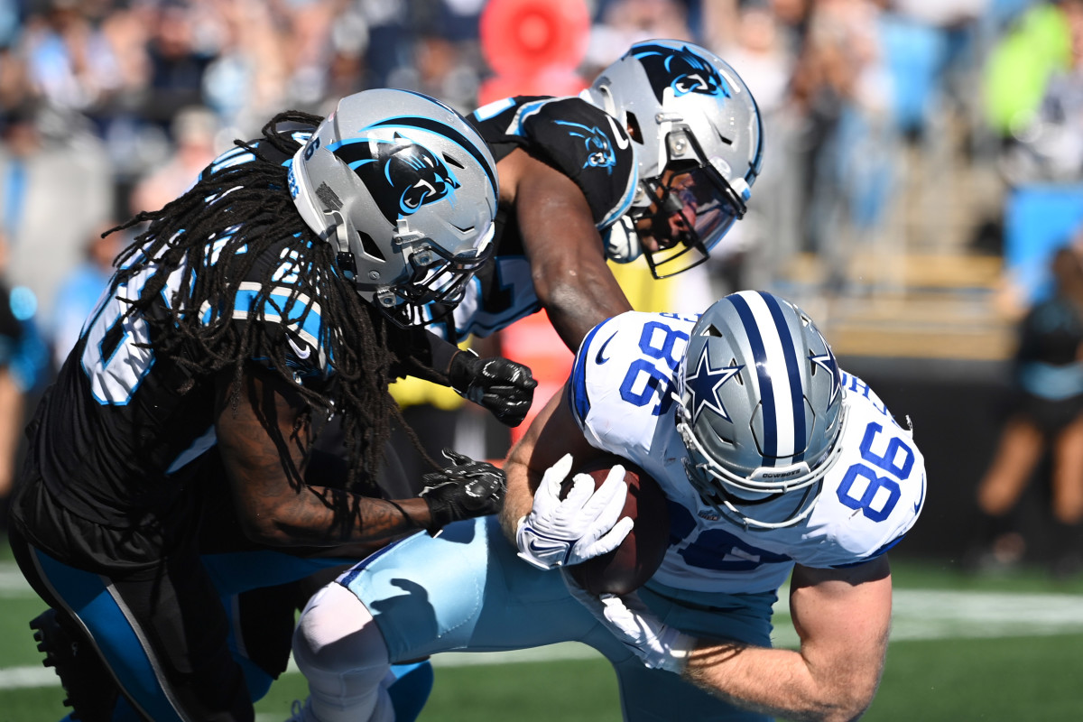 Schoonmaker dives through two Carolina defenders during Sunday's game.