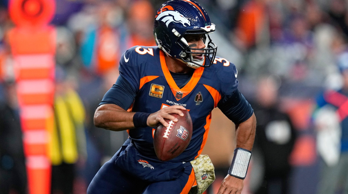 Denver Broncos quarterback Russell Wilson (3) scrambles against the Minnesota Vikings during the first half on an NFL football game, Sunday, Nov. 19, 2023, in Denver. (AP Photo/Jack Dempsey)   