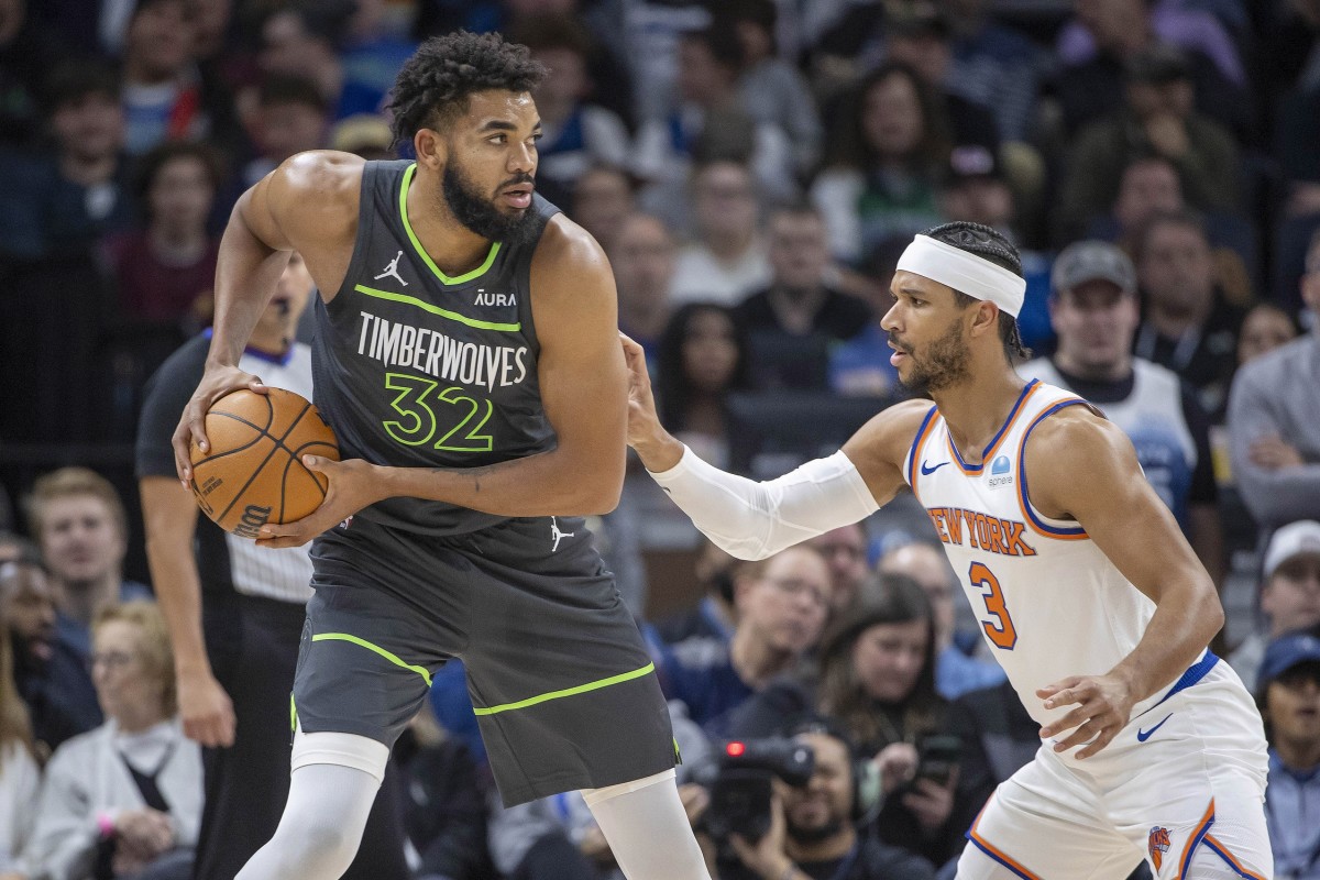 Nov 20, 2023; Minneapolis, Minnesota, USA; Minnesota Timberwolves center Karl-Anthony Towns (32) looks to pass the ball over New York Knicks guard Josh Hart (3) in the first half at Target Center.