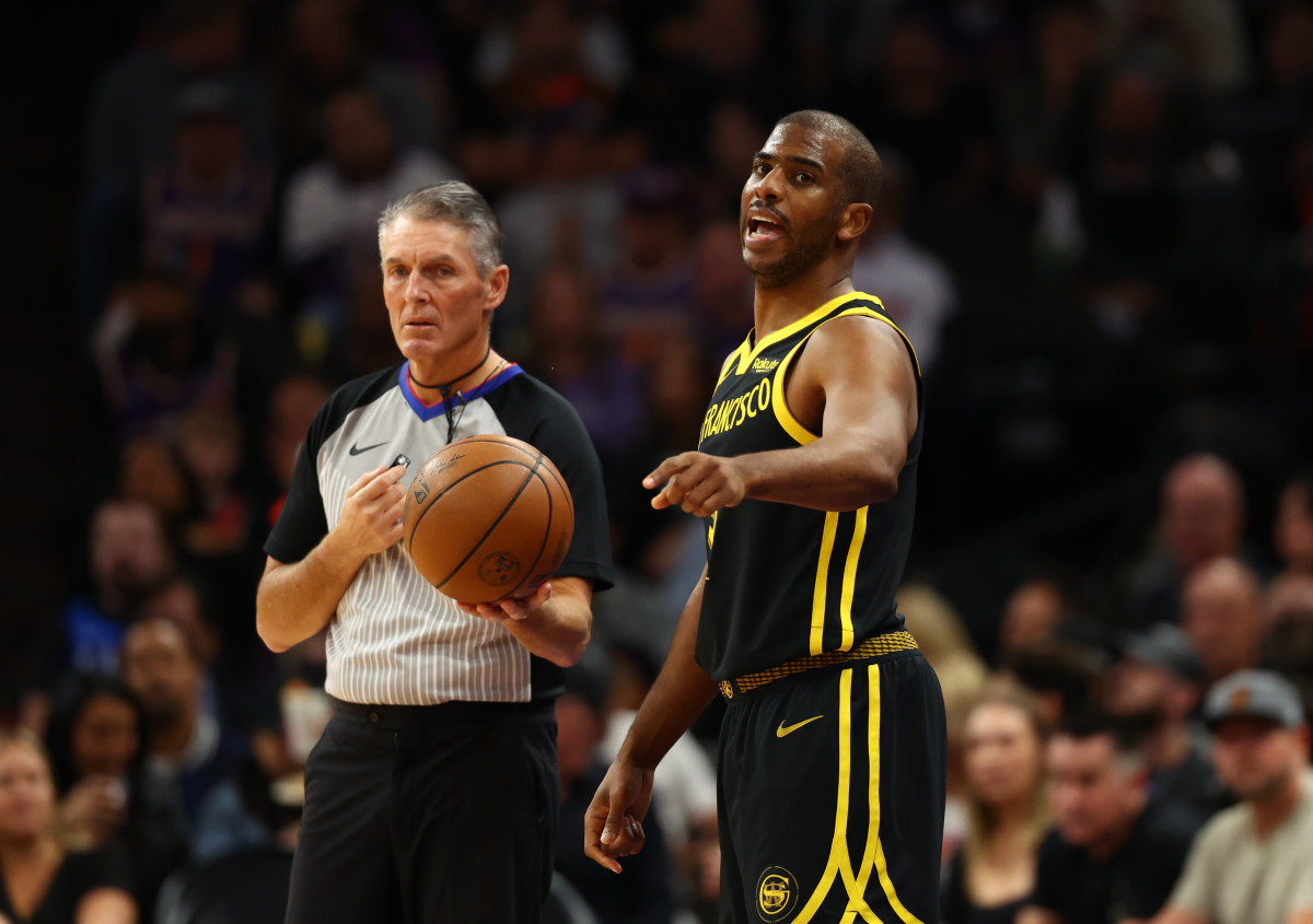 Referee Scott Foster and Warriors guard Chris Paul during Golden State's game against the Suns on Nov. 22, 2023.