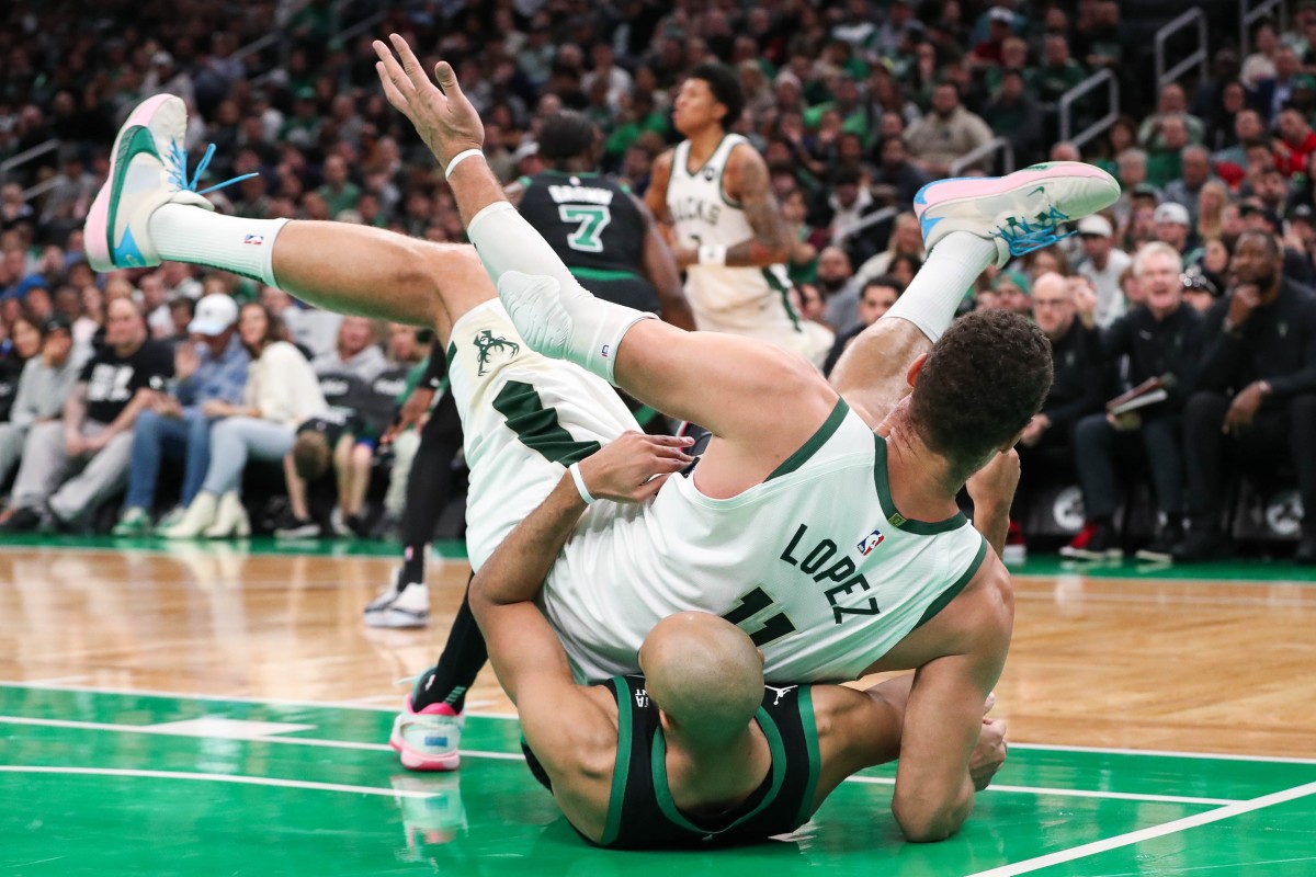 Milwaukee Bucks center Brook Lopez (11) falls on top of Boston Celtics guard Derrick White (9) 