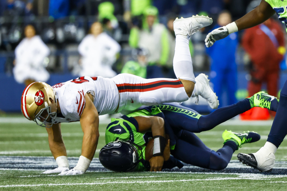 San Francisco 49ers defensive end Nick Bosa (97) sacks Seattle Seahawks quarterback Geno Smith (7) during the fourth quarter at Lumen Field.