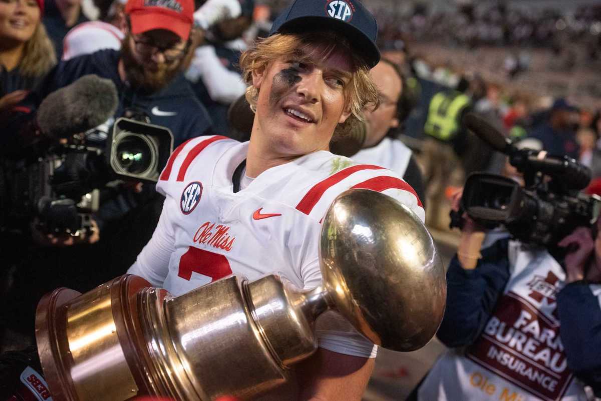 Ole Miss Rebels quarterback Jaxson Dart celebrates with the Golden Egg Trophy following a 17-7 win over the Mississippi State Bulldogs (2023).