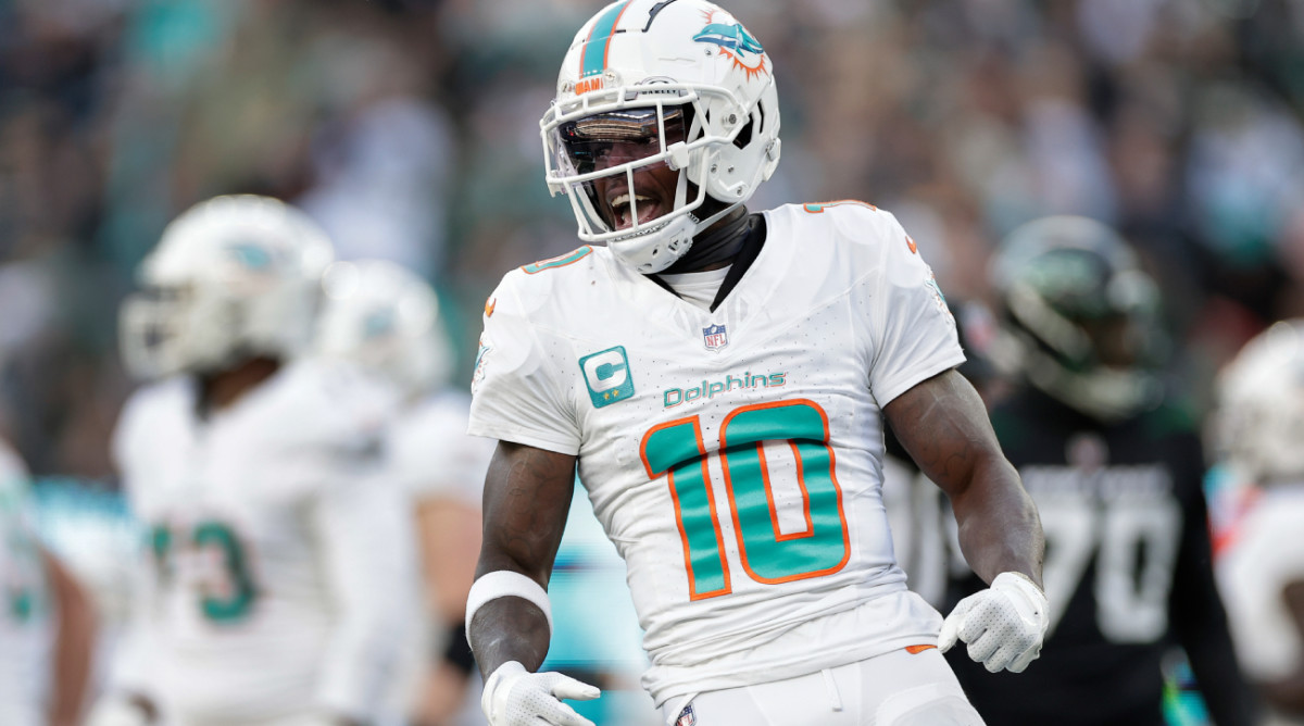 Miami Dolphins wide receiver Tyreek Hill (10) reacts during the first quarter of an NFL football game against the New York Jets, Friday, Nov. 24, 2023, in East Rutherford, N.J. (AP Photo/Adam Hunger)   