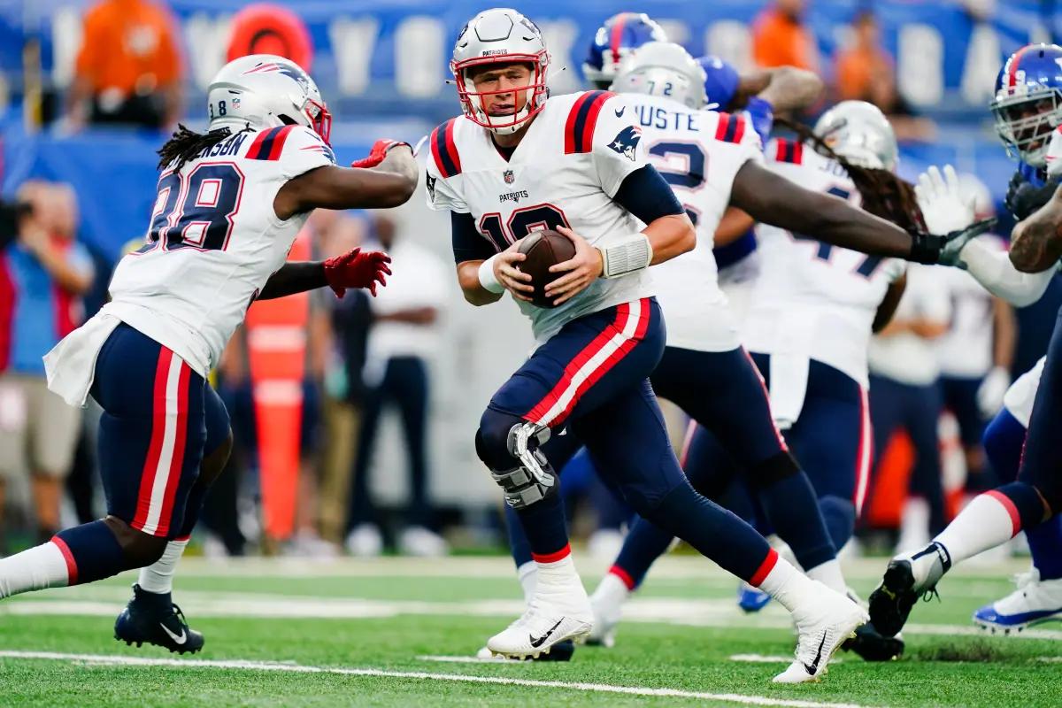 New England Patriots QB Mac Jones drops back to attempt a preseason pass against the New York Giants