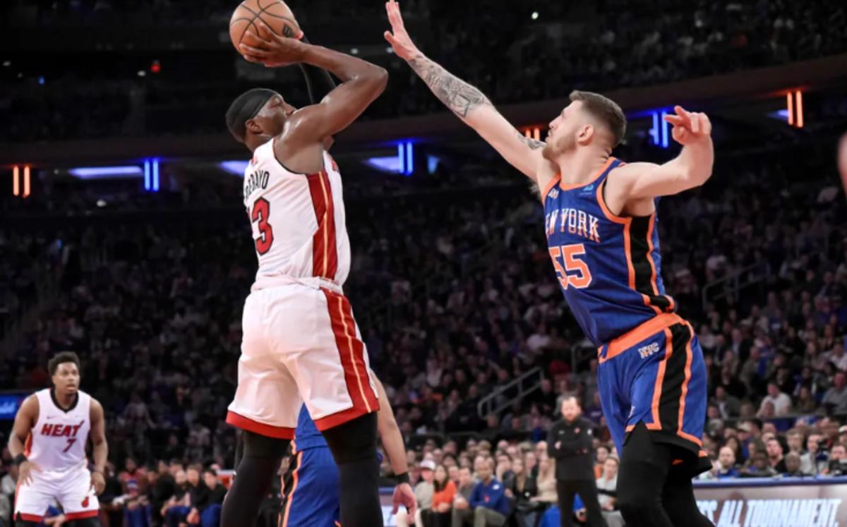 New York Knicks center Isaiah Hartenstein (55) contests a jump shot by Miami Heat forward Jimmy Butler (23)