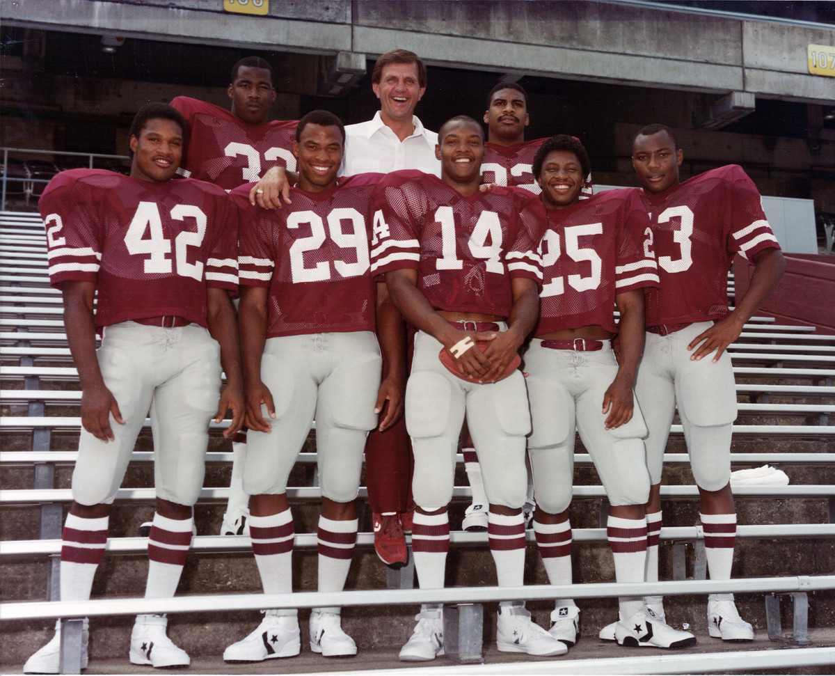 Former Texas A&M Aggies coach Jackie Sherrill stands in the bleachers at Kyle Field with a group of his senior players.