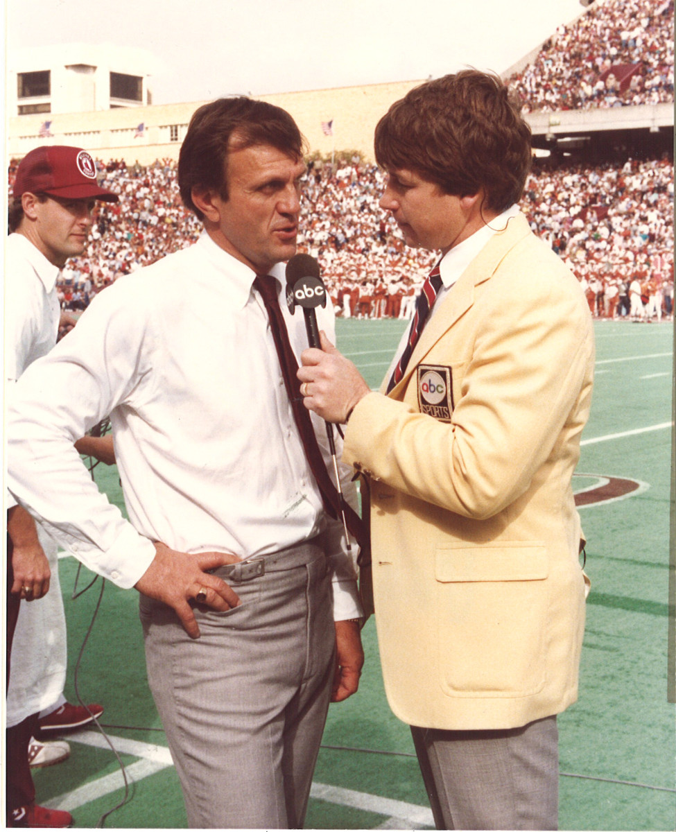 Texas A&M Aggies coach Jackie Sherrill speaks with an ABC reporter on the sideline of a game at Kyle Field.
