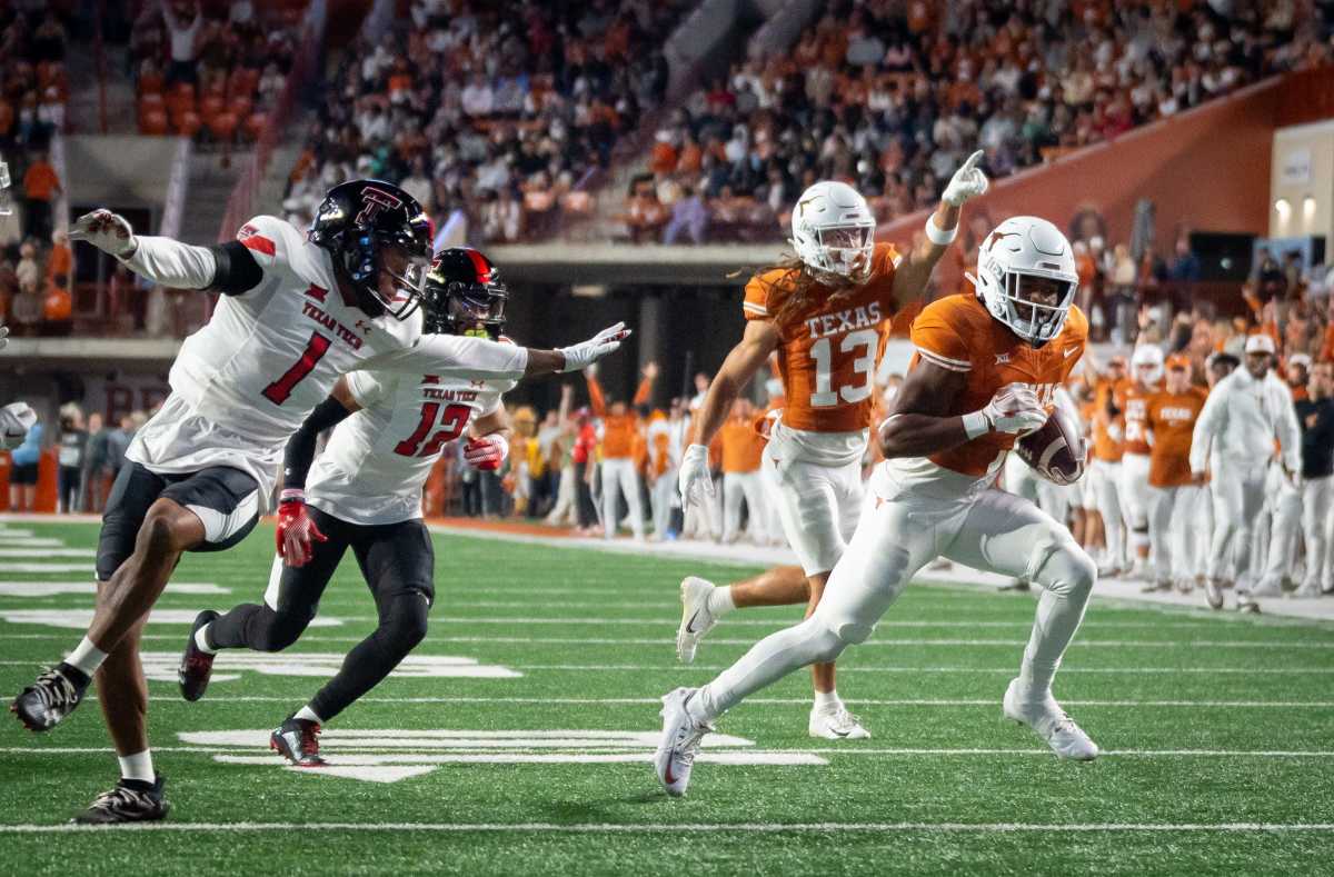 Texas running back Keilan Robinson (7) runs the ball in for the first touchdown of the game, past the Texas Tech defense, during the first quarter of the Longhorns' game against the Red Raiders, Friday, Nov. 24, 2023 at Darrell K Royal-Texas Memorial Stadium in Austin.