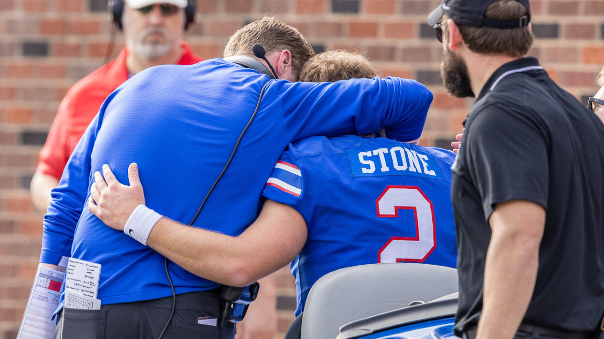 SMU coach Rhett Lashlee consoles quarterback Preston Stone on cart leaving field