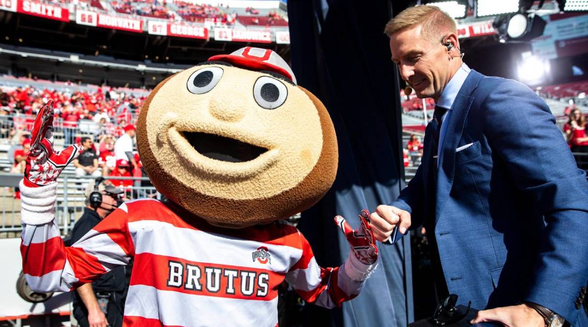 Brutus greets Joel Klatt before a NCAA football game between Iowa and Ohio State, Saturday, Oct. 22, 2022.