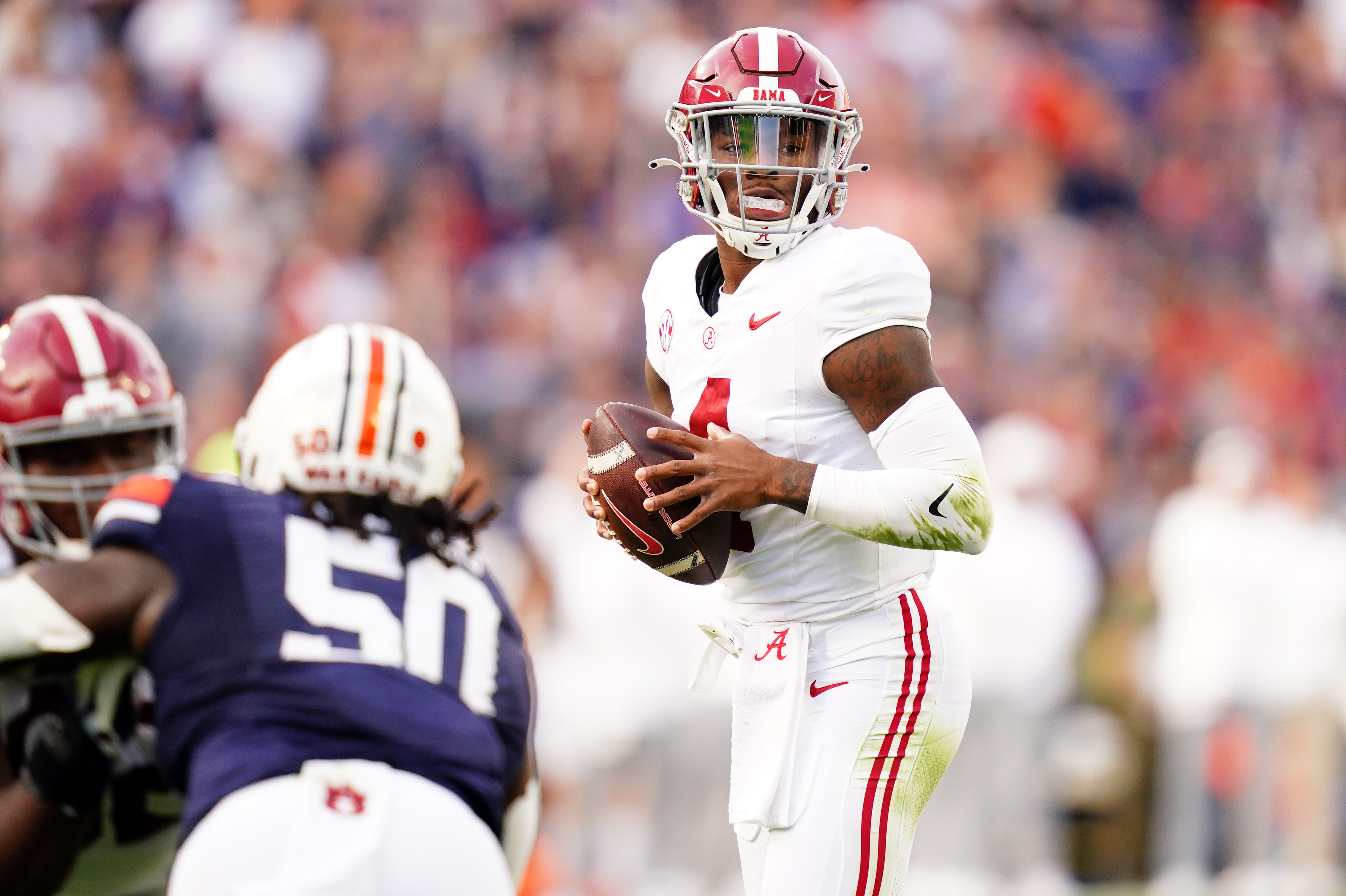 Alabama Crimson Tide quarterback Jalen Milroe (4) looks to pass against the Auburn Tigers during the second quarter at Jordan-Hare Stadium.