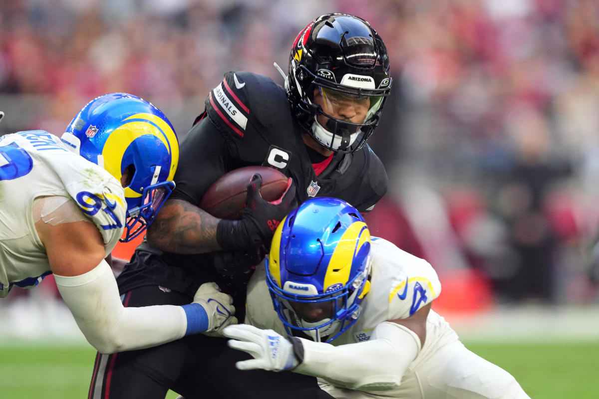 Two Rams defenders bring down Cardinals running back James Conner.