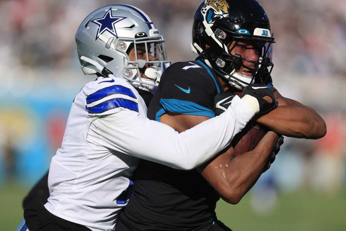 Jacksonville Jaguars wide receiver Zay Jones (7) hauls in a reception for a run and score against Dallas Cowboys cornerback Kelvin Joseph (1) during the third quarter of a regular season NFL football matchup Sunday, Dec. 18, 2022 at TIAA Bank Field in Jacksonville.